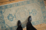 Vintage Oushak runner with platinum and sky blue geometric patterns and worn low pile.