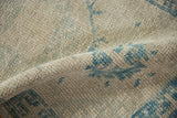 Distressed Oushak rug texture with even wear, faint foundation, and soft powder blue patterns.