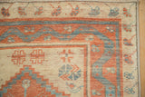 A corner view of the Oushak runner's river-like serpent border and low-pile texture.