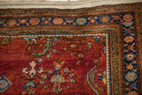 Navy blue and gold floral border turning the corner on a vintage burgundy red Sarouk rug.