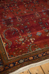 Corner detail of a vintage Sarouk showing color abrashes in the burgundy field and its floral border.