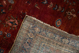 Vintage Sarouk rug corner showing the hand-knotted back and rich burgundy wine pile.