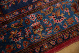 Stylized perched birds and floral sprays in red and brown on an antique Sarouk's sapphire blue pile.