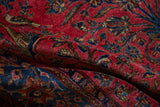 Lustrous raspberry red and sapphire blue wool pile of an antique Sarouk.