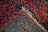Folded corner of an antique Sarouk rug reveals its lustrous pile and fine hand-knotted foundation.