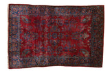 Fine antique Kashan rug with a red floral field, paisley botehs, and a wide sapphire blue border.