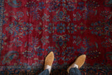 Saturated gem tones of floral bouquets and paisley botehs on an antique Kashan's short pile.