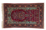 Vintage Dabir Kashan rug with a cherry red Tree of Life design, mint green spandrels, and a navy floral border.