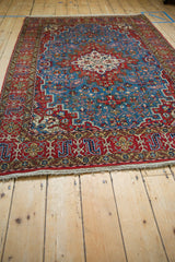 Perspective view showing the vintage Persian Qom's floral medallion and refined geometric patterns.