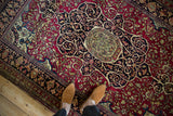 Detailed view of a Collector Isfahan's central medallion with red and navy floral motifs.