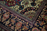 Finely detailed corner spandrel and border of an antique Isfahan rug in cochineal red and dark navy.