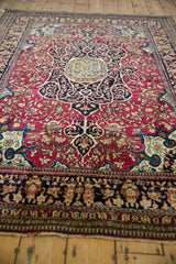 Low angle perspective of a fine Persian Isfahan rug highlighting its rich tones and harmonious layout.