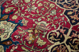 The technical precision and clarity of a fine antique Isfahan rug's hand-knotted floral design.