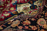 A soft fold in the antique Isfahan rug reveals its fine weave and clear floral motifs.