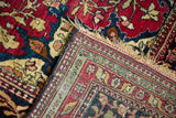 Folded corner of a collector Isfahan rug showing the fine weave and detailed border.