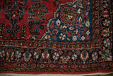 Vivid sapphire blue corner spandrel and floral border on a vintage Persian Sarouk rug.