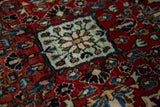 Close-up on the dense, short pile of a vintage Sarouk, showing a powder blue medallion.