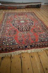 Low angle view of the vintage Sarouk's brick red field and central blue medallion.