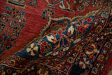 Dense, hand-knotted pile of a vintage Sarouk rug with a sapphire blue floral border.
