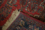 The hand-knotted foundation and secured selvage of a vintage Persian Sarouk rug's corner.