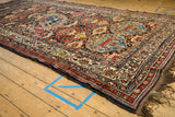 Side profile of a collector's antique Afshar runner showing the intricate floral medallion field.