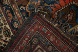 Antique Afshar rug corner folded to show the hand-knotted pile and woven foundation.