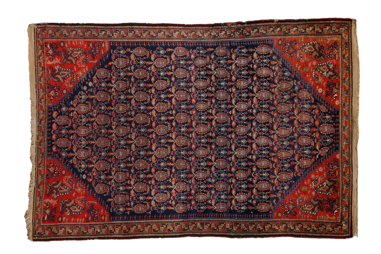Antique Persian Malayer rug with navy blue field, allover boteh design, and red geometric border.