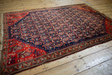 Antique Malayer rug's storied side edge, displaying its tomato red geometric border.