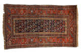 Antique Kurdish Hamadan rug, navy geometric boteh field, brick red serrated floral border, circa 1910.