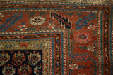 Antique Kurdish Hamadan rug corner showcasing brick red serrated leaf border and geometric field motifs.