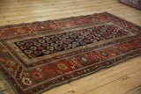 Antique Kurdish Hamadan rug: navy geometric botehs and brick red serrated leaf border.