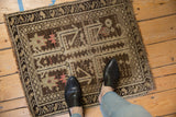 Small antique Caucasian rug with geometric motifs shown in context for scale.