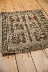 Angled view of a circa 1920s Caucasian mat revealing its even, low pile and intricate geometric design.