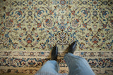 Close-up of the fine pile on a vintage Kashan showing Rococo-stylized leaves and vines.