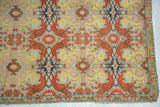 Safavid-style motifs and shimmering silver thread on a corner of the antique Persian textile.