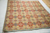 Angled view of an antique Persian compound cloth showing its intricate repeating botanical pattern.