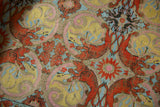 Close-up of the intricate weave and lustrous silver thread of an antique compound cloth.
