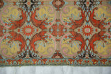 Antique Persian textile showing terracotta tigers, a butterfly border, and the raw, truncated lower edge.