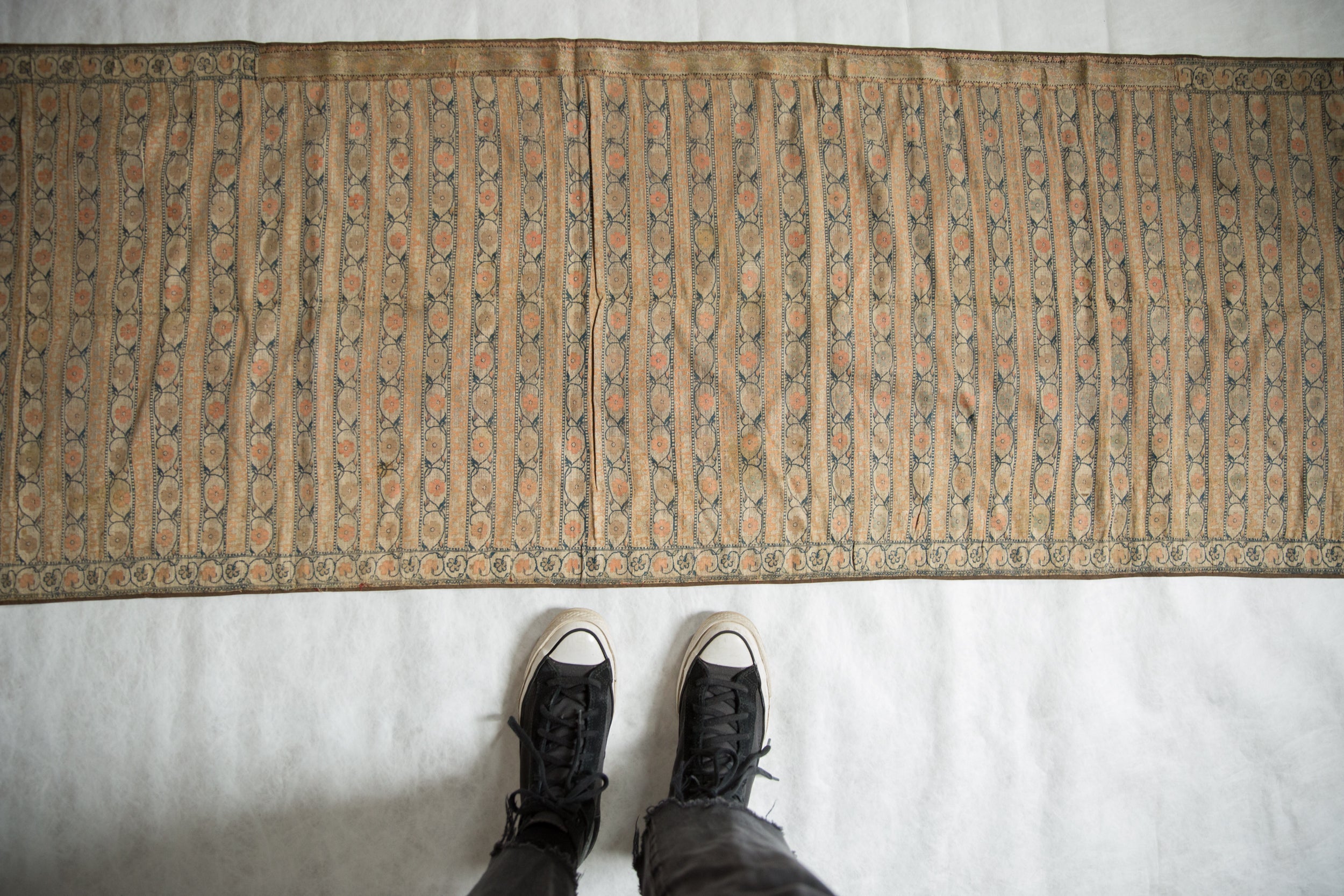 Finely rendered stripes with delicate floral motifs on an antique silk brocade sash.