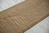 Finely rendered stripes and floral motifs on the brocaded silk of an antique Persian sash.