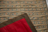 Corner of an antique Persian sash showing the floral brocade and contrasting red silk backing.
