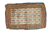 An 18th century Persian velvet textile with stylized human figures and a warm, multi-striped border.