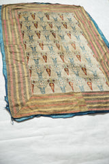 Corner of the 18th-century Persian velvet textile contrasts the striped border with its soft blue backing.