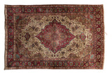 Antique silk Mohtashem Kashan rug with a burgundy shield medallion and scrolling vines on an ivory field.