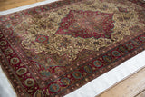 Angled view showing the fine, lustrous pile and intricate floral design of an antique silk Kashan rug.