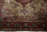 Fine weave showing intricate floral arabesques in aubergine and sapphire on an antique Kashan rug.