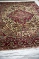 The supple, pliable silk body of an antique Mohtashem Kashan rug seen from a low angle.