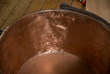 Interior view of the antique copper kettle highlighting the hand-hammered texture and braised seam.