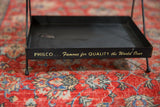 Gold script slogan on the front of the black vintage Philco metal display stand.