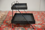 Side profile of the vintage Philco display stand showing its two-tiered metal construction.